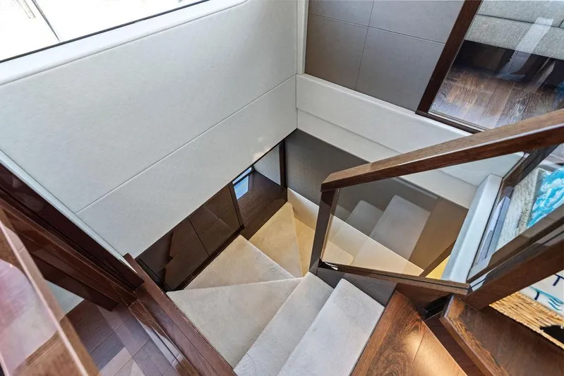 Tempus Fugit Yacht Photos Pics Staircase inside 2019 Sunseeker 76 Yacht with elegant wood and glass design.