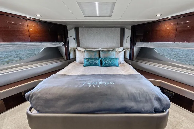 Tempus Fugit Yacht Photos Pics Luxurious bedroom interior of 2019 Sunseeker 76 Yacht with elegant bedding and panoramic windows.