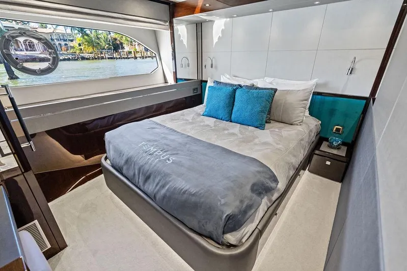 Tempus Fugit Yacht Photos Pics Luxurious bedroom interior of 2019 Sunseeker 76 Yacht with elegant bedding and waterfront view.