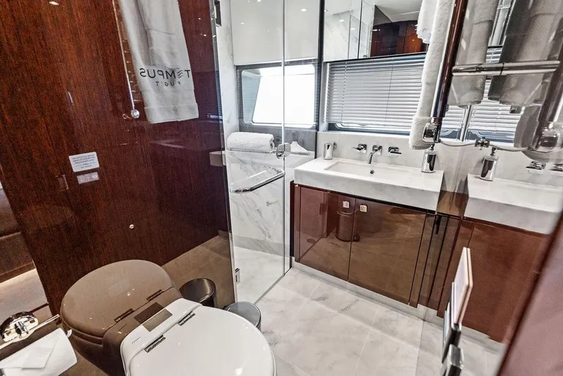 Tempus Fugit Yacht Photos Pics Luxurious bathroom in a 2019 Sunseeker 76 Yacht, featuring elegant fixtures and modern design.