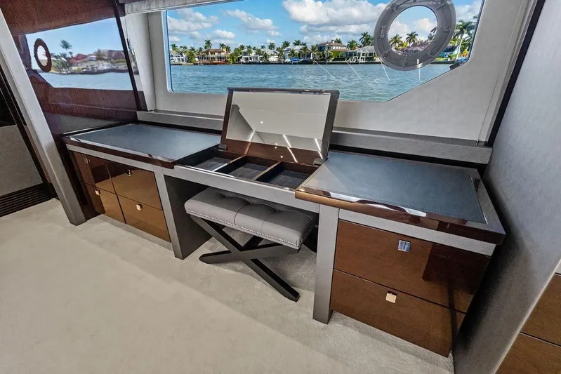 Tempus Fugit Yacht Photos Pics Luxurious interior of 2019 Sunseeker 76 Yacht with elegant desk and waterfront view.