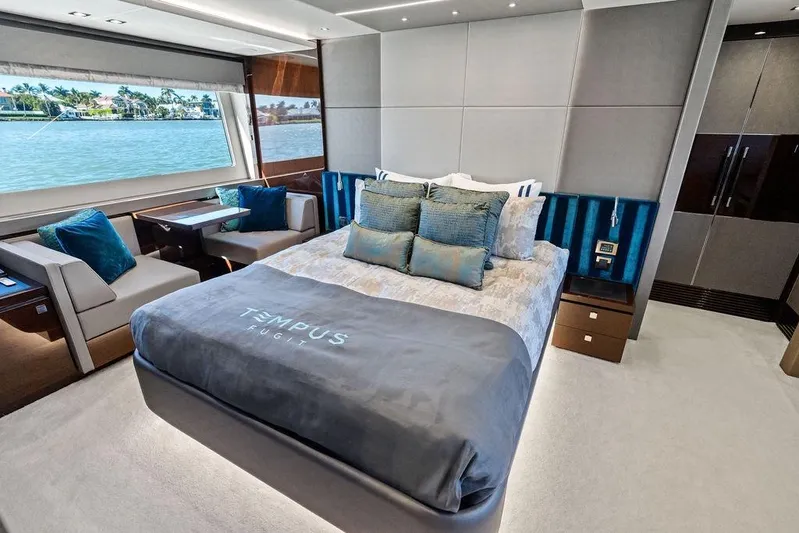 Tempus Fugit Yacht Photos Pics Luxurious interior of 2019 Sunseeker 76 Yacht with elegant bedroom and scenic ocean view.
