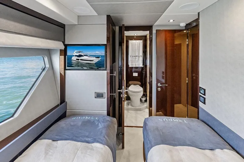 Tempus Fugit Yacht Photos Pics Luxurious interior of 2019 Sunseeker 76 Yacht with twin beds and en-suite bathroom.