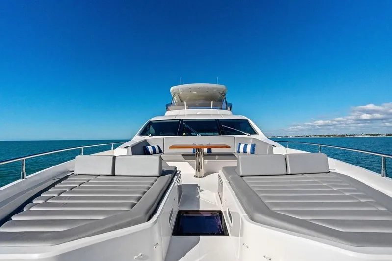 Tempus Fugit Yacht Photos Pics Luxurious 2019 Sunseeker 76 Yacht with sun loungers on open sea.