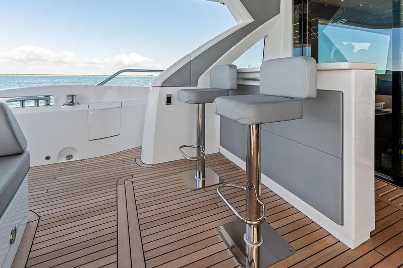 Tempus Fugit Yacht Photos Pics Luxury Sunseeker 76 Yacht 2019 deck with modern bar stools and ocean view.