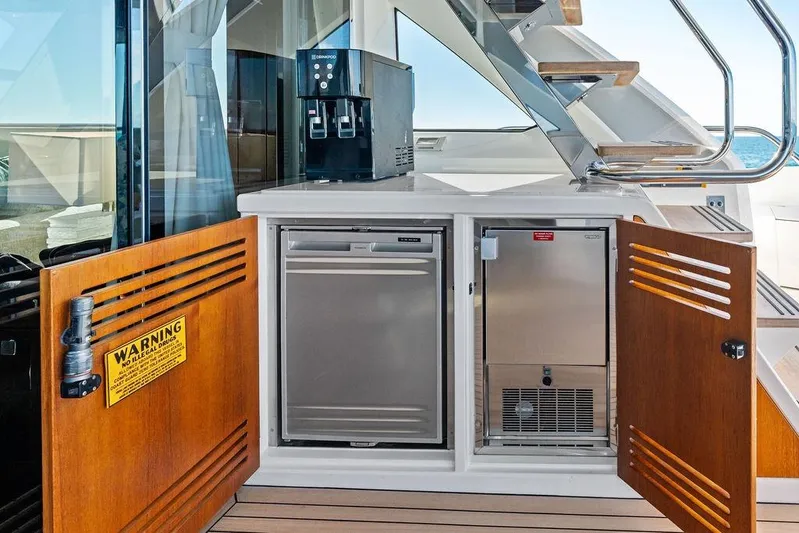 Tempus Fugit Yacht Photos Pics Sunseeker 76 Yacht 2019 interior with open cabinets and coffee machine.