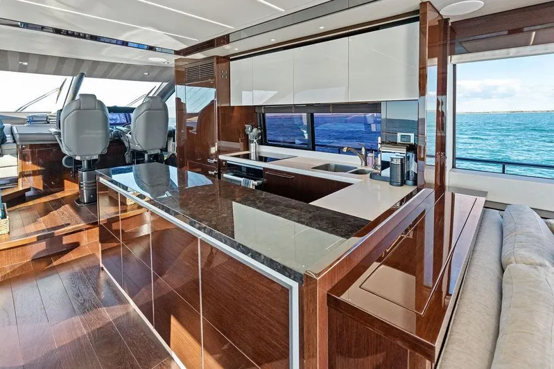Tempus Fugit Yacht Photos Pics Luxurious interior of 2019 Sunseeker 76 Yacht with modern kitchen and ocean view.
