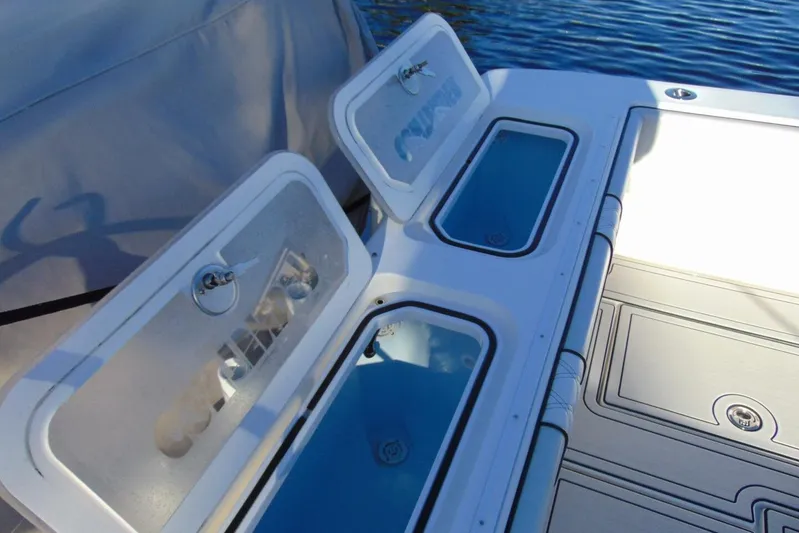 Atlas Yacht Photos Pics 2023 Contender 39 Fisharound boat with open storage compartments on deck.