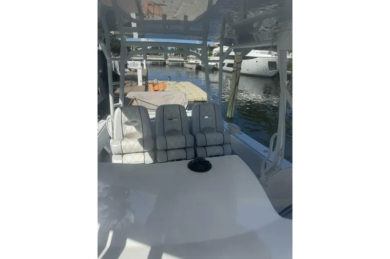 Atlas Yacht Photos Pics 2023 Contender 39 Fisharound boat interior with seating, docked by the water.