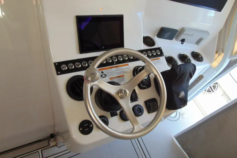 Atlas Yacht Photos Pics 2023 Contender 39 Fisharound helm with steering wheel and control panel.