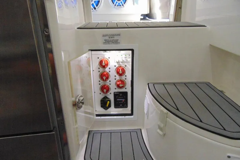 Atlas Yacht Photos Pics Control panel inside 2023 Contender 39 Fisharound boat, featuring red switches and seating.