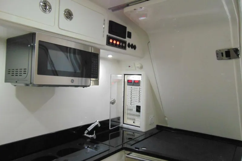 Atlas Yacht Photos Pics 2023 Contender 39 Fisharound interior with microwave, sink, and control panel.