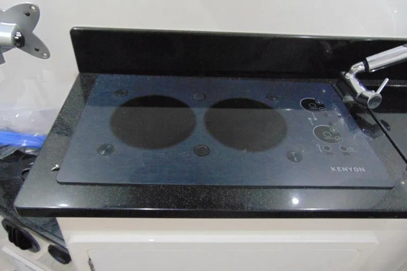 Atlas Yacht Photos Pics Kenyon cooktop on 2023 Contender 39 Fisharound boat, sleek black design.