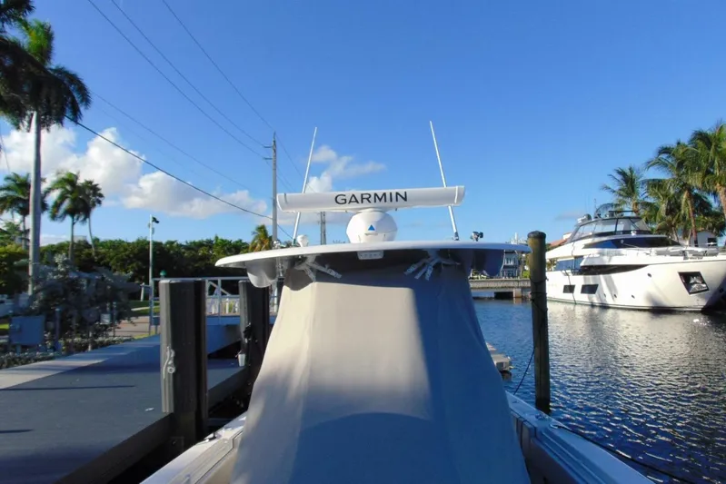 Atlas Yacht Photos Pics 2023 Contender 39 Fisharound docked, featuring Garmin equipment, under clear blue sky.