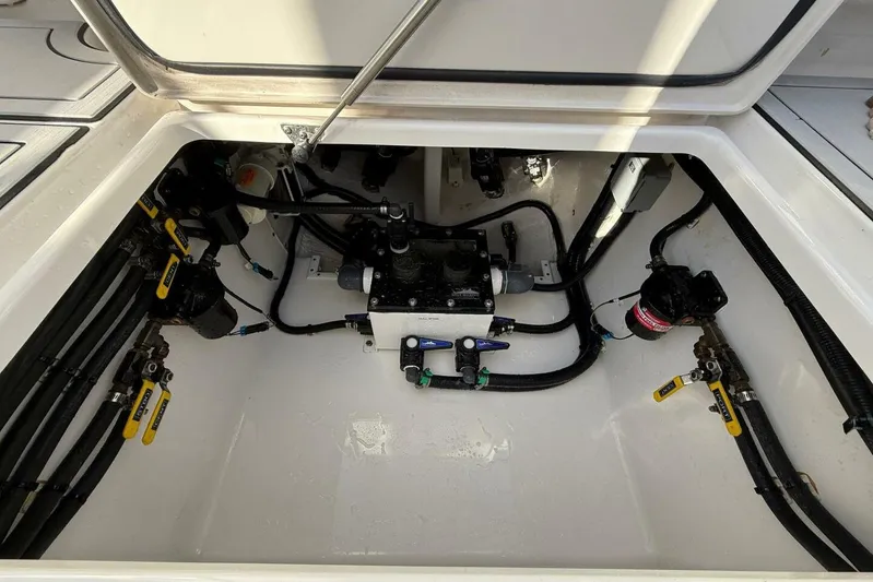 Atlas Yacht Photos Pics 2023 Contender 39 Fisharound boat engine compartment with visible wiring and components.
