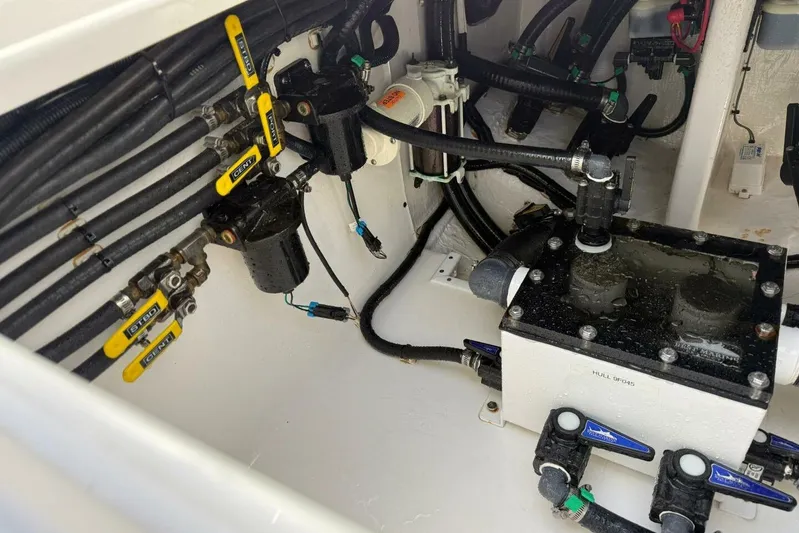 Atlas Yacht Photos Pics Engine compartment of 2023 Contender 39 Fisharound with visible valves and hoses.