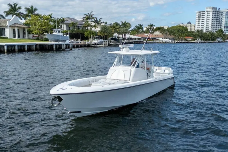 Atlas Yacht Photos Pics 2023 Contender 39 Fisharound boat cruising on a scenic waterfront.
