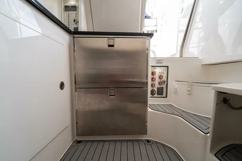 Atlas Yacht Photos Pics 2023 Contender 39 Fisharound interior with stainless steel storage and control panel.
