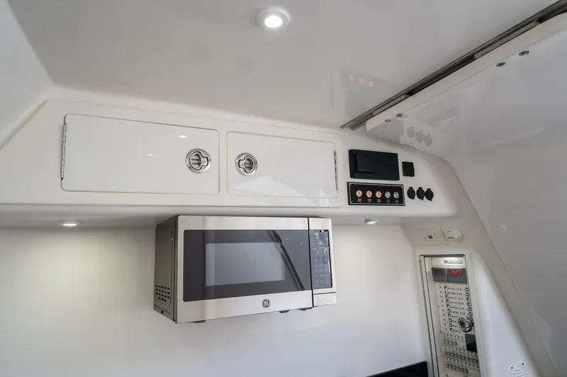 Atlas Yacht Photos Pics 2023 Contender 39 Fisharound interior with microwave and control panel.