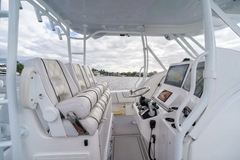 Atlas Yacht Photos Pics 2023 Contender 39 Fisharound boat interior with helm, seating, and navigation equipment.