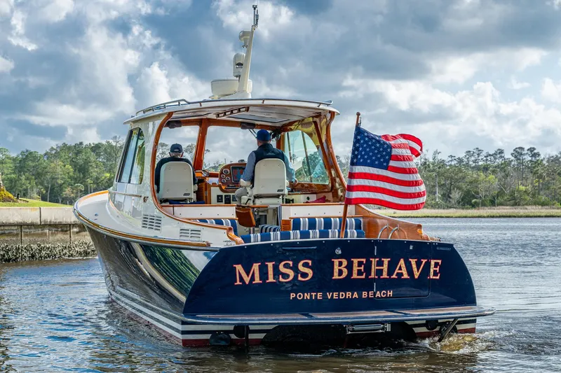 Miss Behave Yacht Photos Pics 2017 Hinckley Picnic Boat 37 MKIII cruising with American flag, named "Miss Behave."