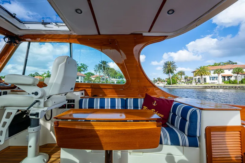 Miss Behave Yacht Photos Pics 2017 Hinckley Picnic Boat 37 MKIII interior with elegant seating and waterfront view.