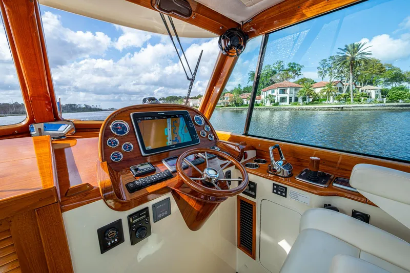 Miss Behave Yacht Photos Pics Helm of 2017 Hinckley Picnic Boat 37 MKIII with scenic waterfront view.