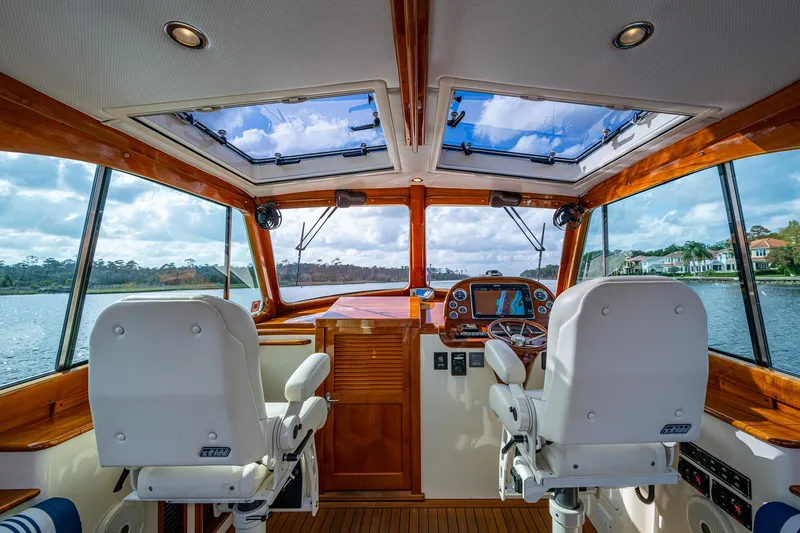Miss Behave Yacht Photos Pics Interior view of 2017 Hinckley Picnic Boat 37 MKIII helm with dual seats and panoramic windows.