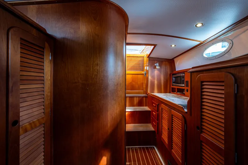 Miss Behave Yacht Photos Pics Interior of 2017 Hinckley Picnic Boat 37 MKIII with wooden cabinetry and ambient lighting.