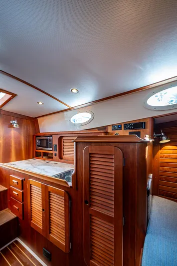 Miss Behave Yacht Photos Pics 2017 Hinckley Picnic Boat 37 MKIII interior with wood cabinetry and modern amenities.