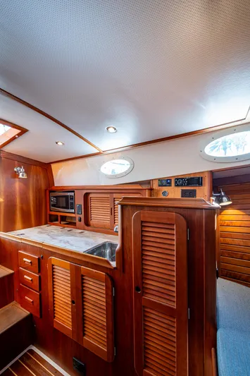 Miss Behave Yacht Photos Pics 2017 Hinckley Picnic Boat 37 MKIII interior with wood cabinetry and modern amenities.