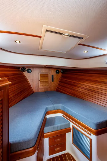 Miss Behave Yacht Photos Pics 2017 Hinckley Picnic Boat 37 MKIII cabin with wooden interior and cozy bedding.