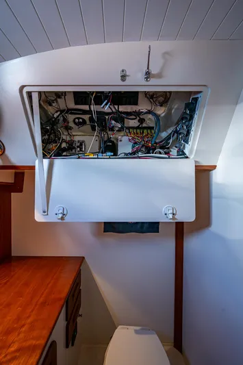 Miss Behave Yacht Photos Pics Hinckley Picnic Boat 37 MKIII 2017 interior showing open electrical panel above a toilet.