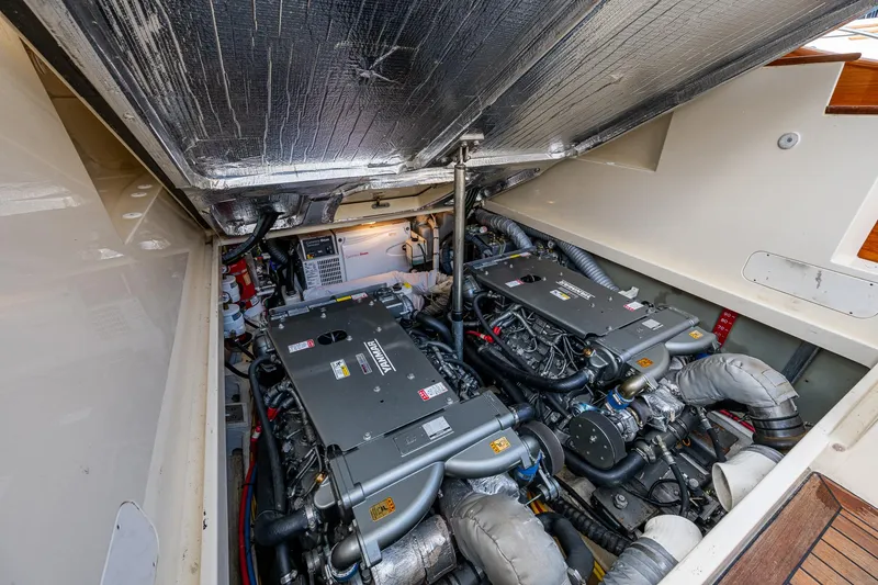 Miss Behave Yacht Photos Pics Engine compartment of 2017 Hinckley Picnic Boat 37 MKIII, showcasing dual engines and mechanical components.