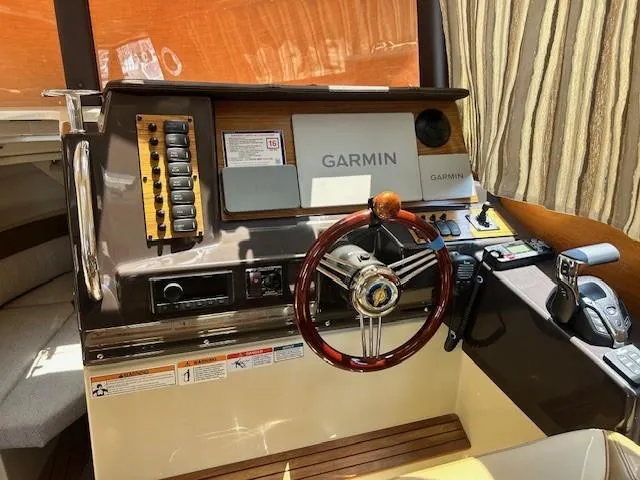  Yacht Photos Pics 2024 Ranger Luxury Edition boat dashboard with Garmin navigation and wooden steering wheel.