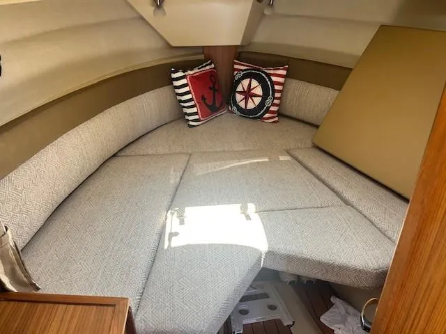  Yacht Photos Pics 2024 Ranger Luxury Edition boat interior with cozy seating and nautical-themed cushions.