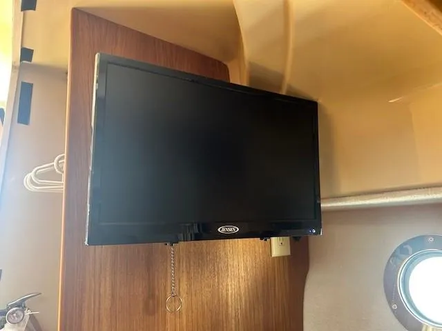  Yacht Photos Pics 2024 Ranger Luxury Edition interior with mounted flat-screen TV and wooden paneling.