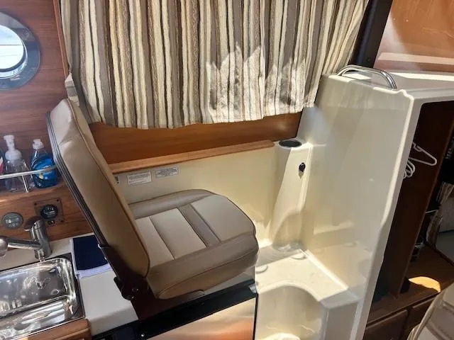  Yacht Photos Pics 2024 Ranger Luxury Edition interior with leather seating and compact kitchenette.