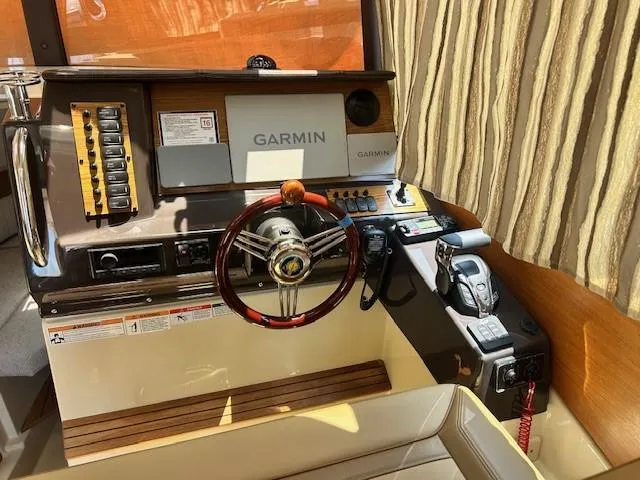  Yacht Photos Pics 2024 Ranger Luxury Edition boat cockpit with Garmin navigation system and elegant steering wheel.