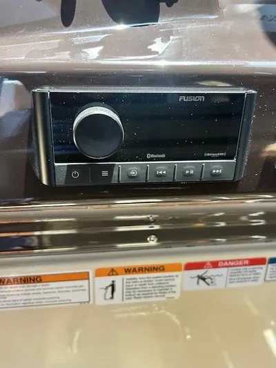  Yacht Photos Pics 2024 Ranger Luxury Edition audio system with control panel and warning labels.