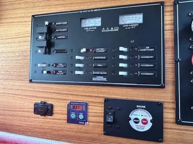  Yacht Photos Pics 2024 Ranger Luxury Edition control panel with voltage and current meters on wooden surface.