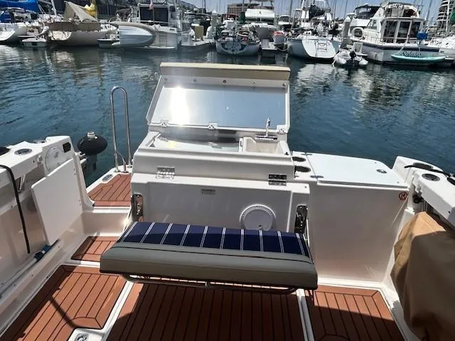  Yacht Photos Pics 2024 Ranger Luxury Edition boat with open deck, docked at marina.