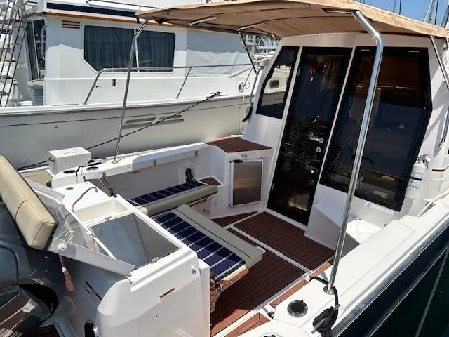  Yacht Photos Pics 2024 Ranger Luxury Edition boat with spacious deck and seating, docked at marina.