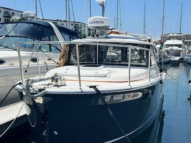  Yacht Photos Pics 2024 Ranger Luxury Edition boat docked in marina, featuring Garmin navigation system.