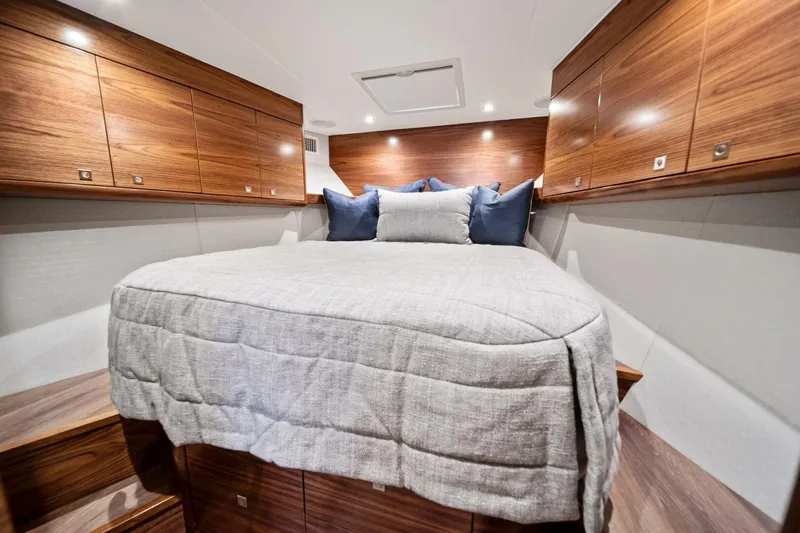 New Viking 46 Billfish Yacht Photos Pics Luxurious cabin interior of 2026 Viking 46 Billfish yacht with cozy bedding and wooden cabinetry.