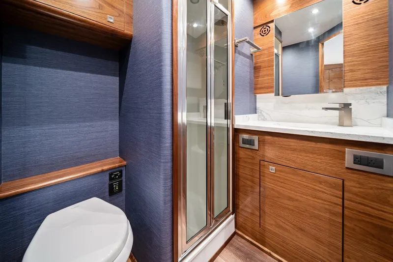 New Viking 46 Billfish Yacht Photos Pics Luxurious bathroom in 2026 Viking 46 Billfish yacht with modern fixtures and wood accents.