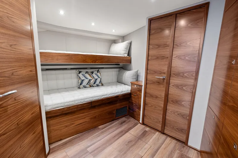 New Viking 46 Billfish Yacht Photos Pics Luxurious cabin interior of 2026 Viking 46 Billfish with wooden finishes and bunk beds.