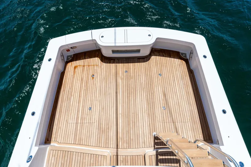 New Viking 46 Billfish Yacht Photos Pics Spacious deck of 2026 Viking 46 Billfish yacht with wooden flooring, surrounded by ocean water.