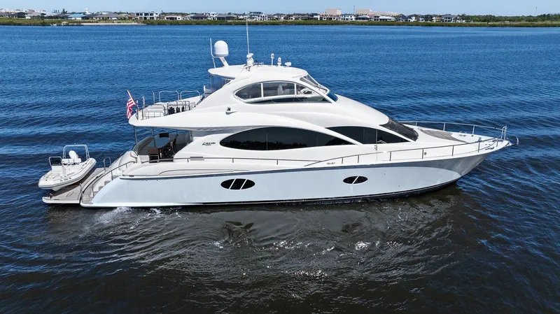  Yacht Photos Pics 2005 Lazzara 68 Pilothouse Motoryacht cruising on calm blue waters.