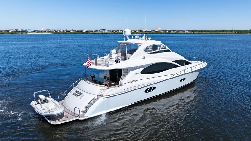  Yacht Photos Pics 2005 Lazzara 68 Pilothouse Motoryacht cruising on calm waters, showcasing sleek design and luxury.